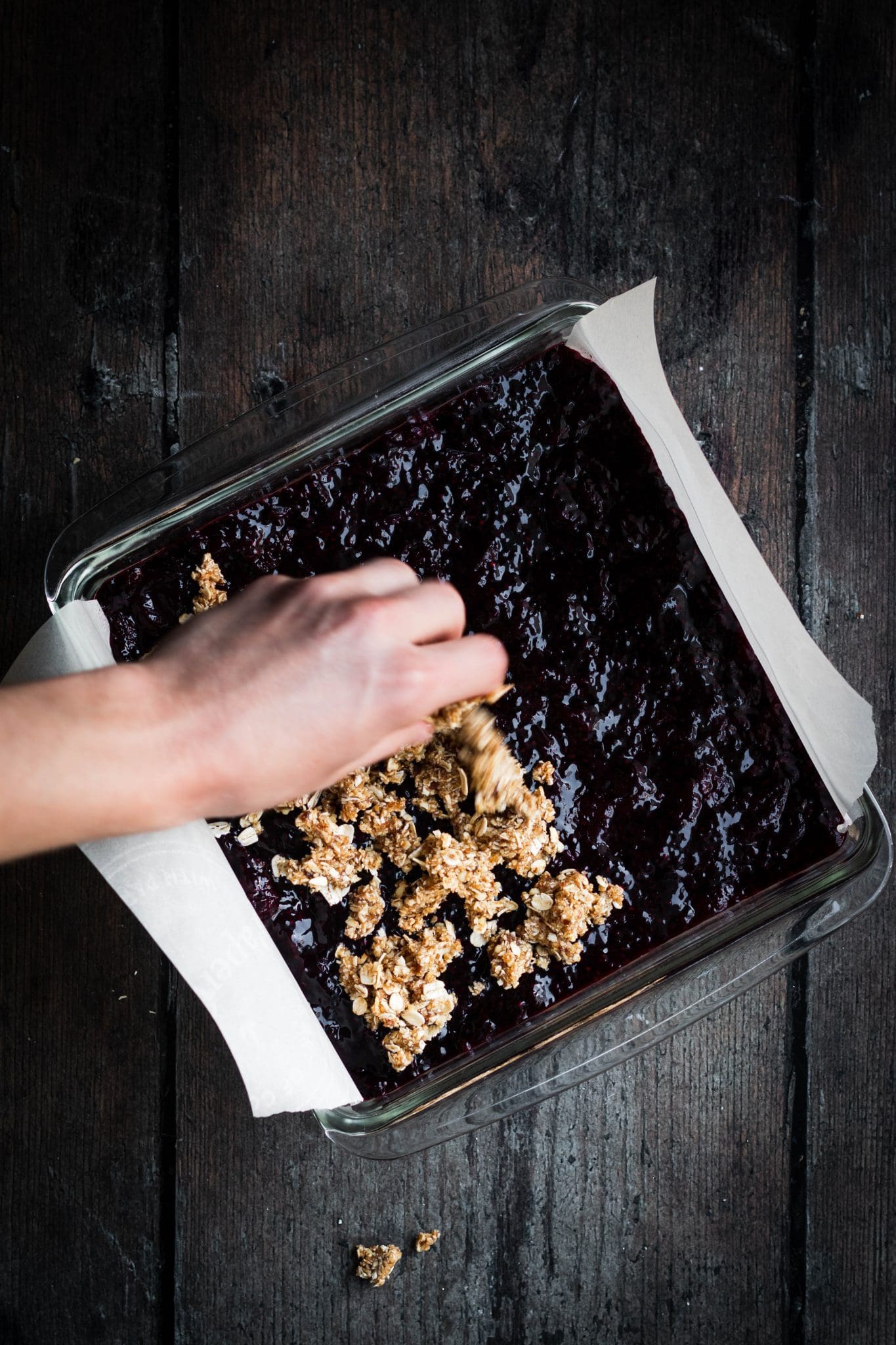cherry chia jam crumble bars in a glass dish with crumble spread on top