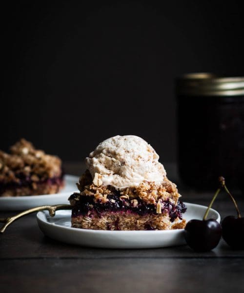cherry chia jam crumble bar with a scoop of ice cream