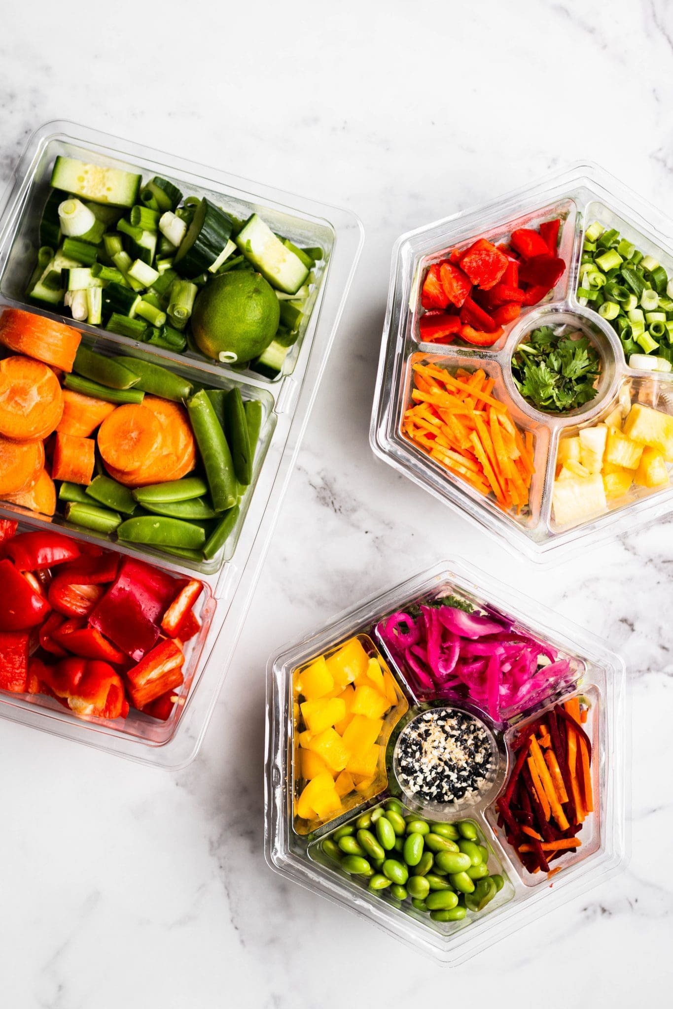 meal prep salads and vegetables in containers seen from the top
