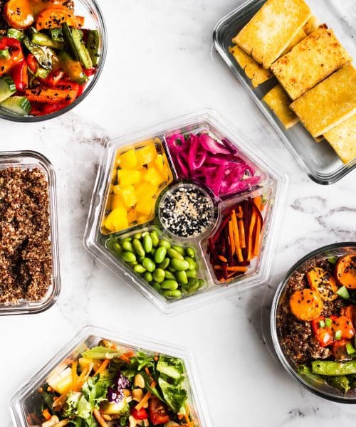prepared salads, quinoa and tofu in meal prep containers