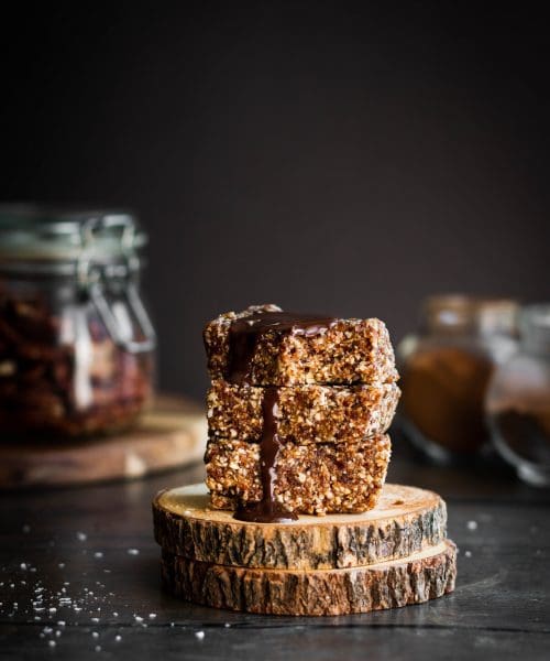 stack of three no-bake spiced pecan granola bars with chocolate on top