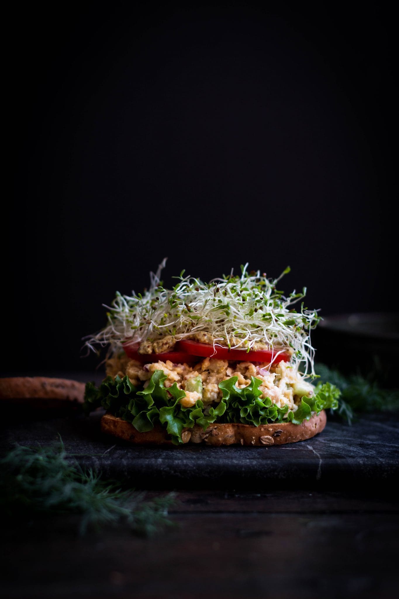 opened chickpea salad sandwich seen from the side