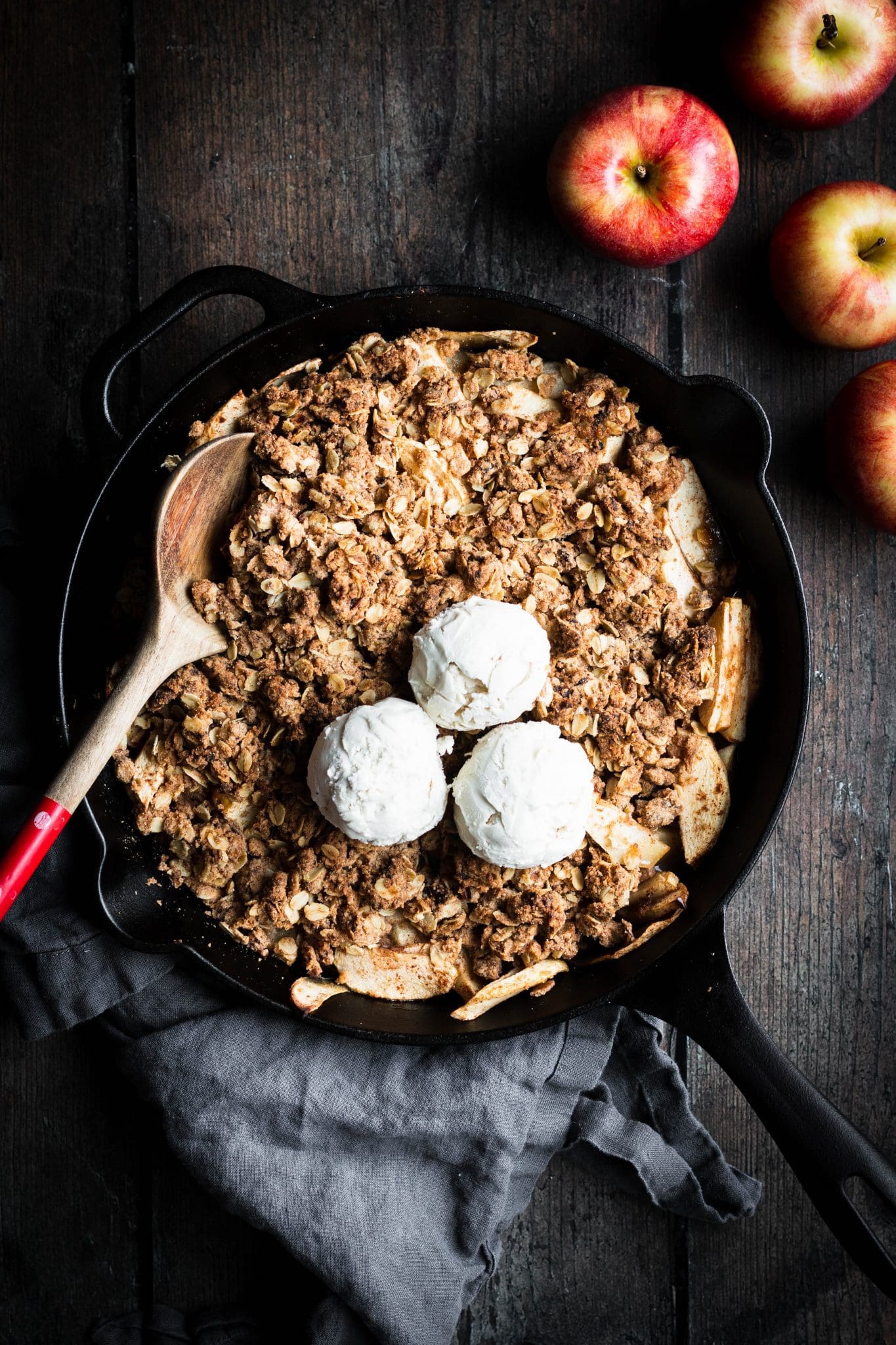 fruit-sweetened apple crisp in a cast-iron skillet with ice cream on top