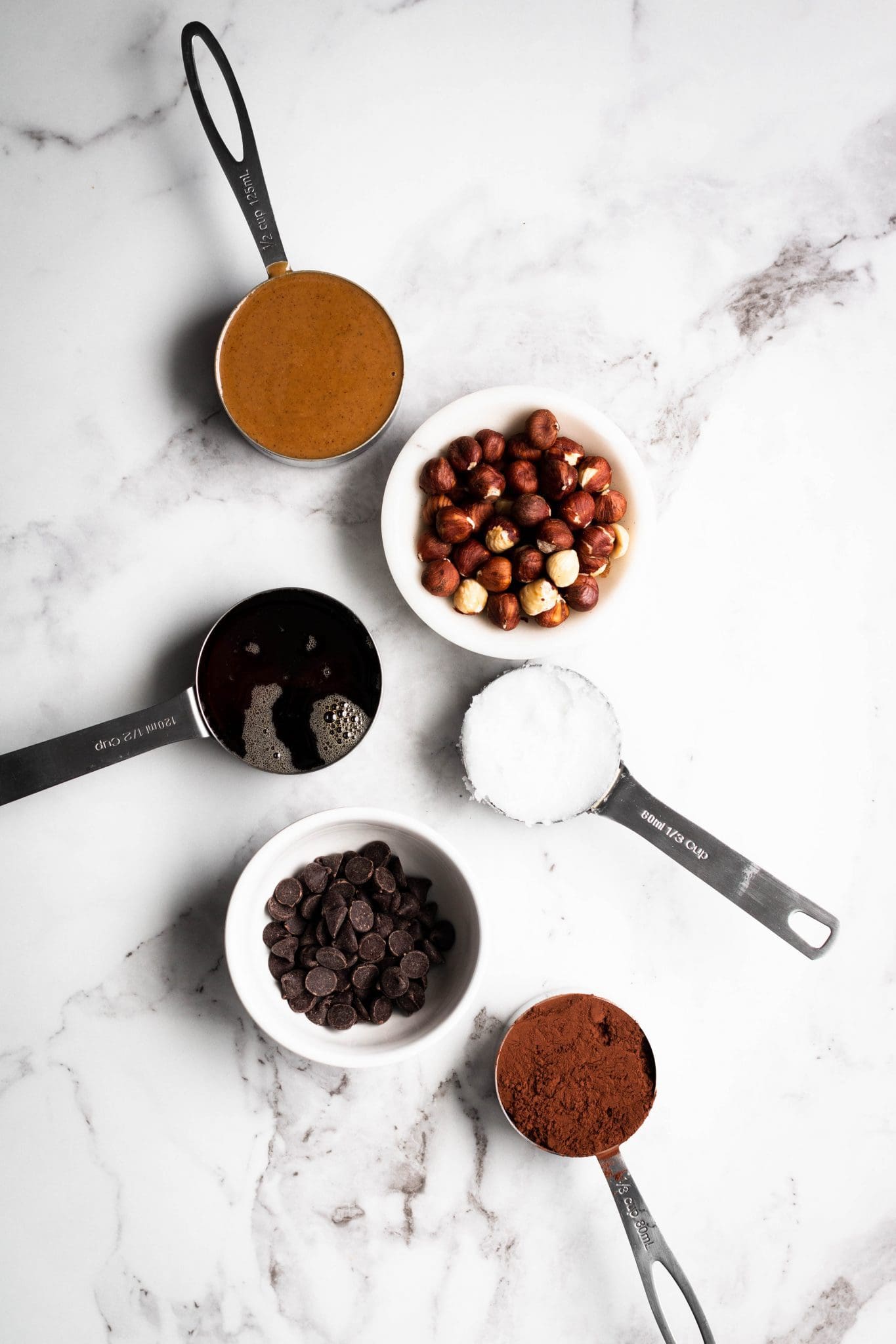 chocolate hazelnut fudge ingredients in measuring cups and bowls seen from the top