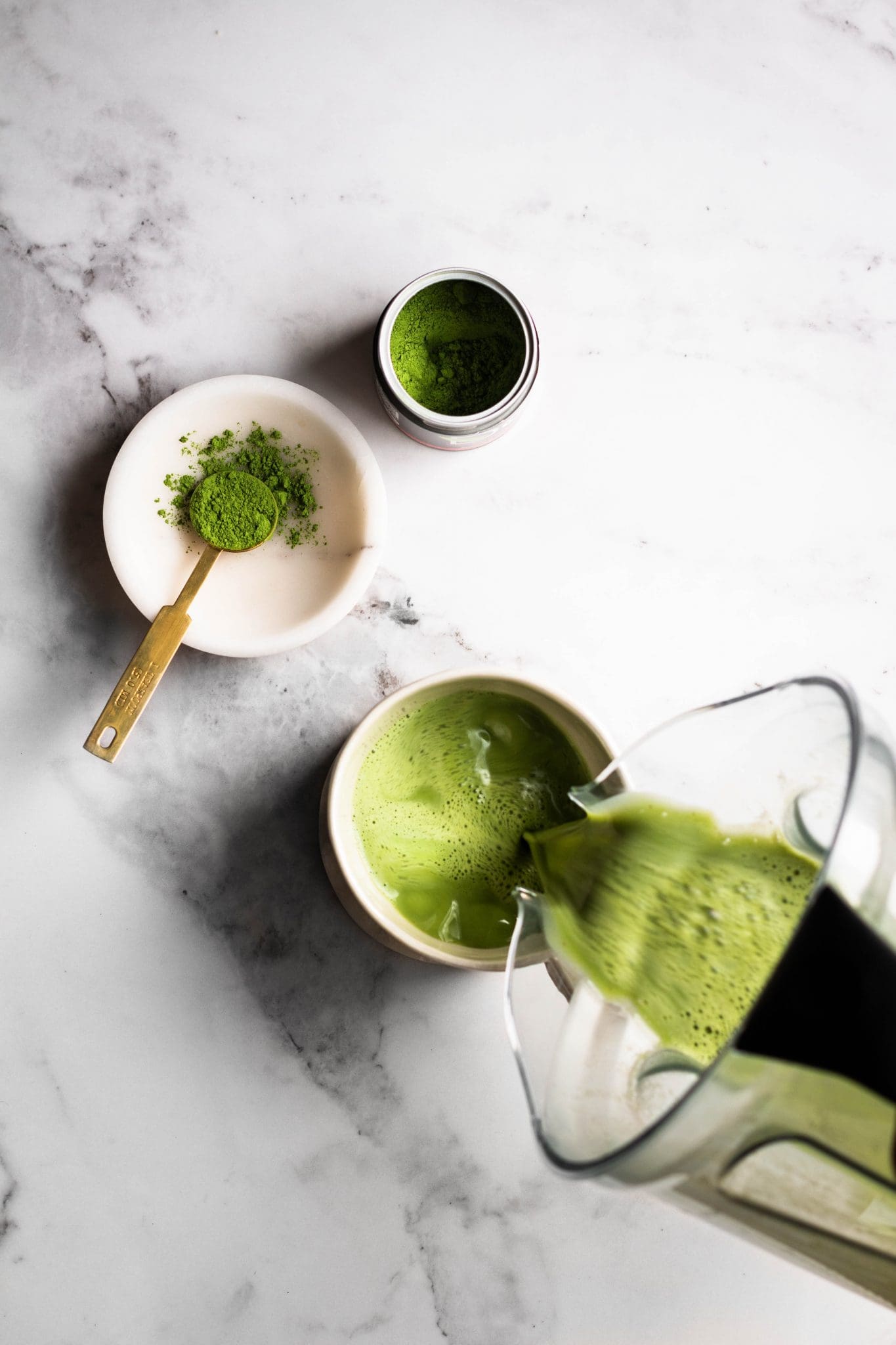 blender oat milk matcha latte poured in a cup