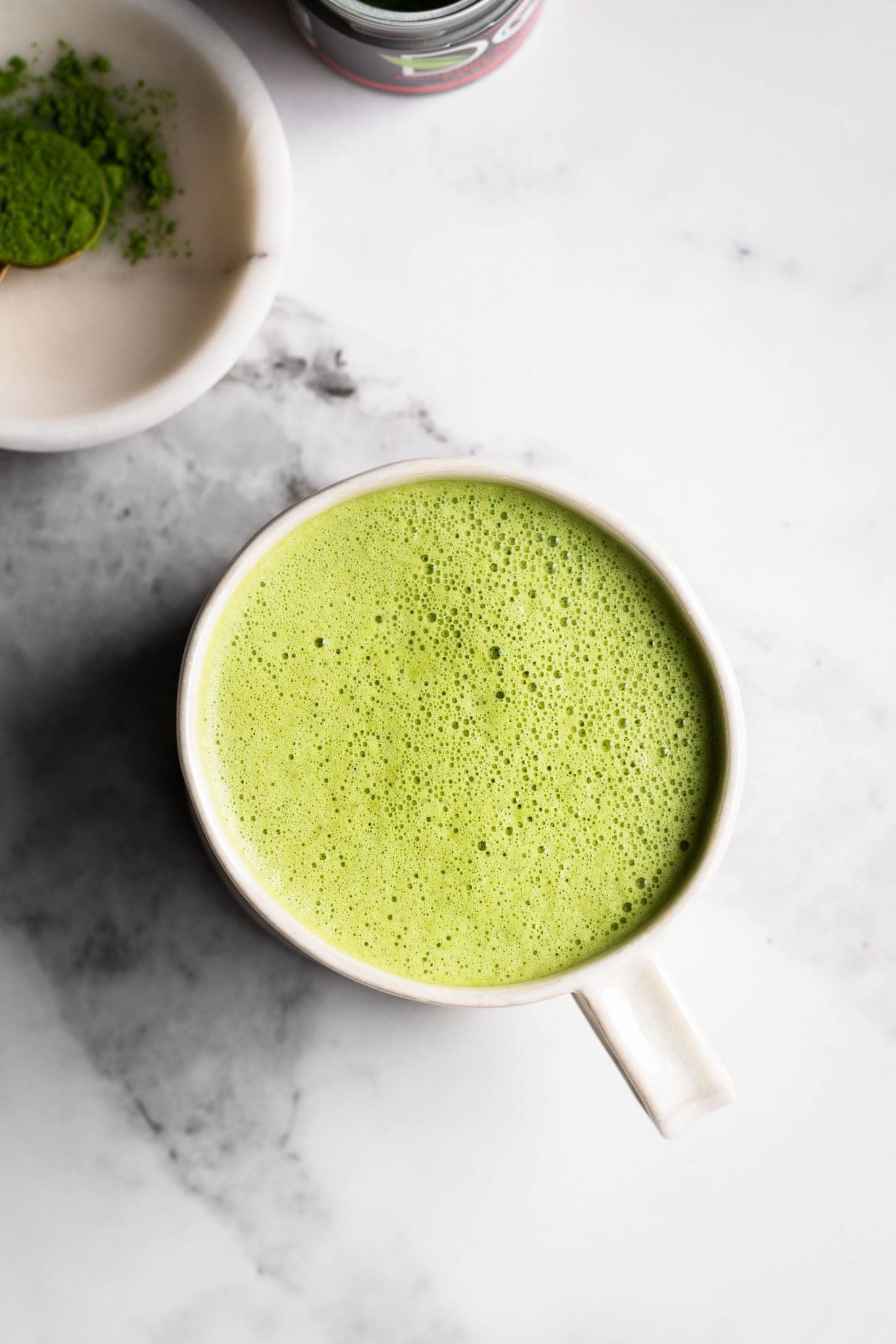 oat milk matcha latte in a cup seen from the top