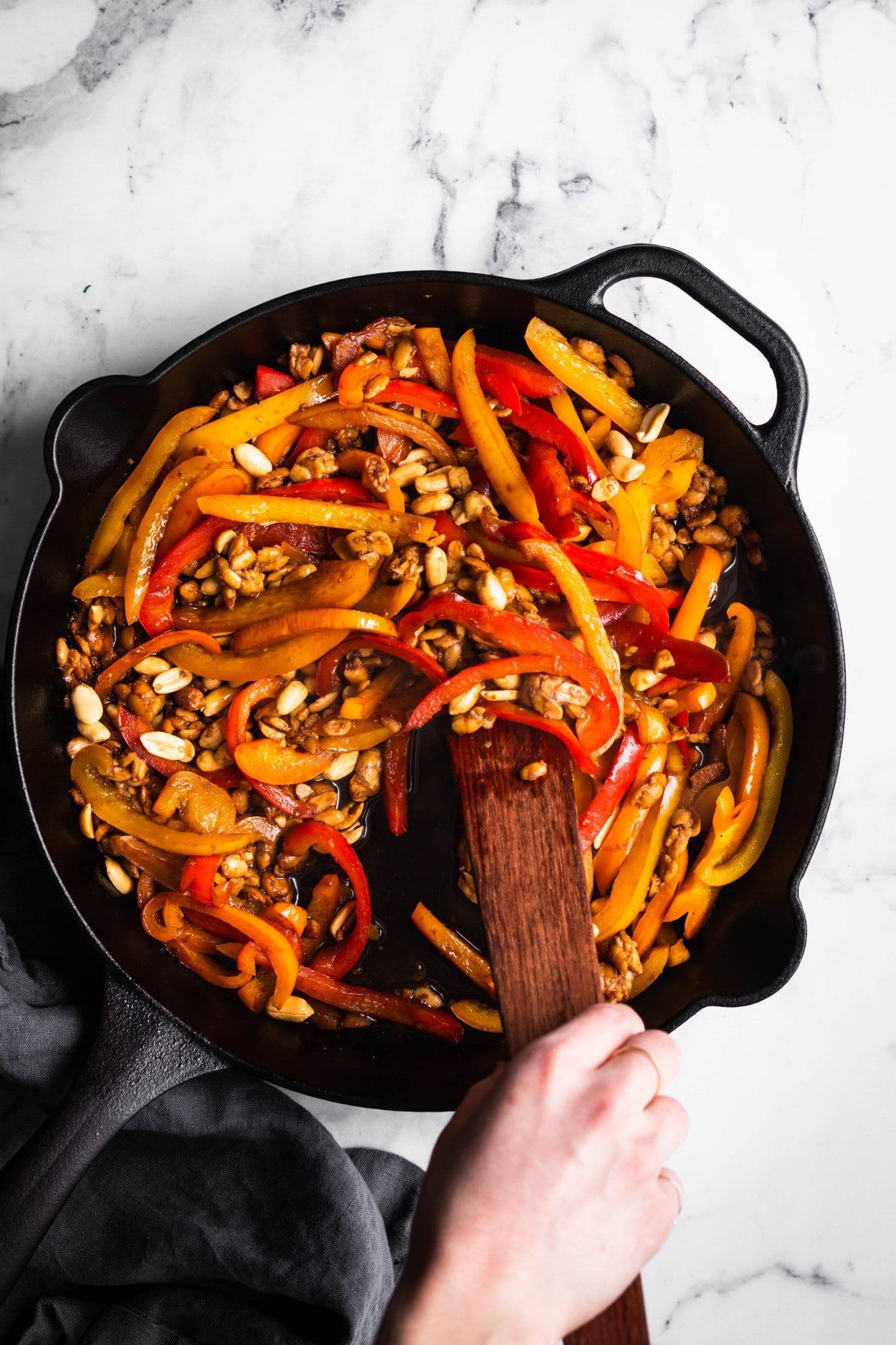 sliced bell peppers and crumbled tempeh in a cast-iron skillet