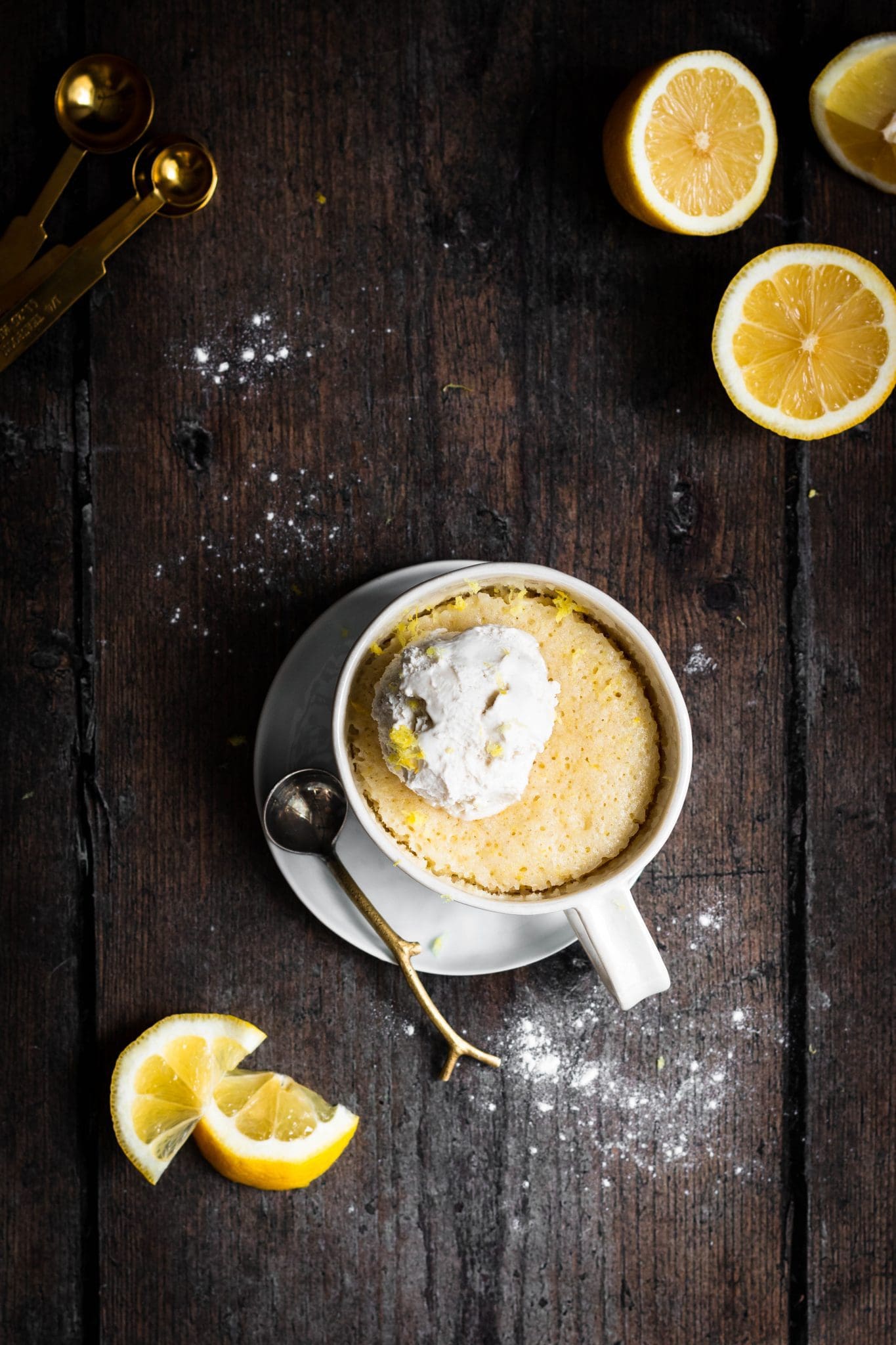 lemon mug cake with a scoop of ice cream and lemon slices