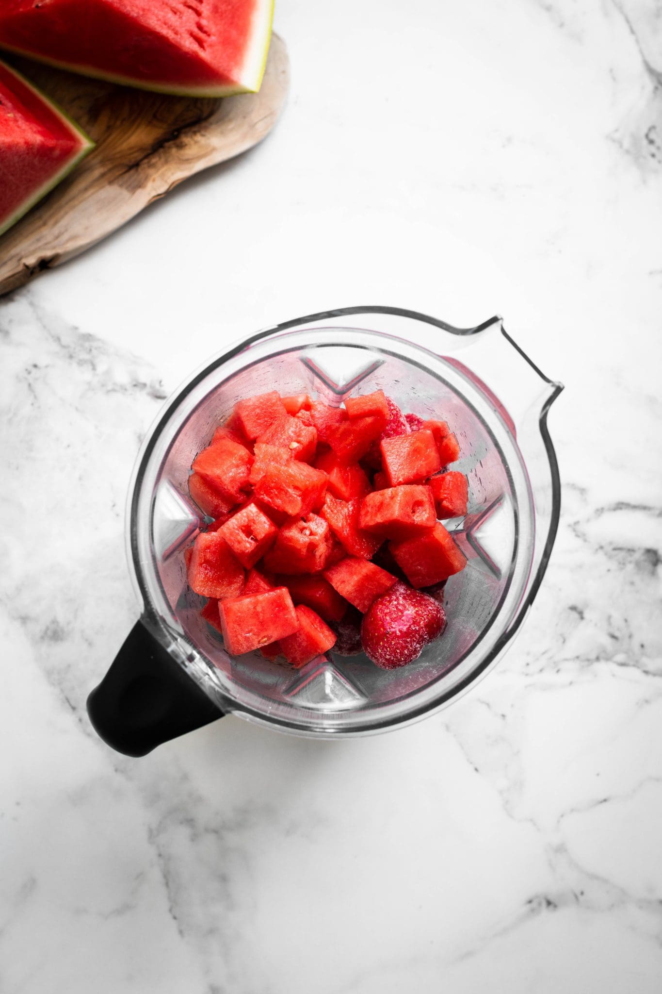 diced watermelon and strawberries in a blender