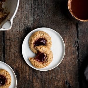 almond strawberry thumbprint cookies on a plate