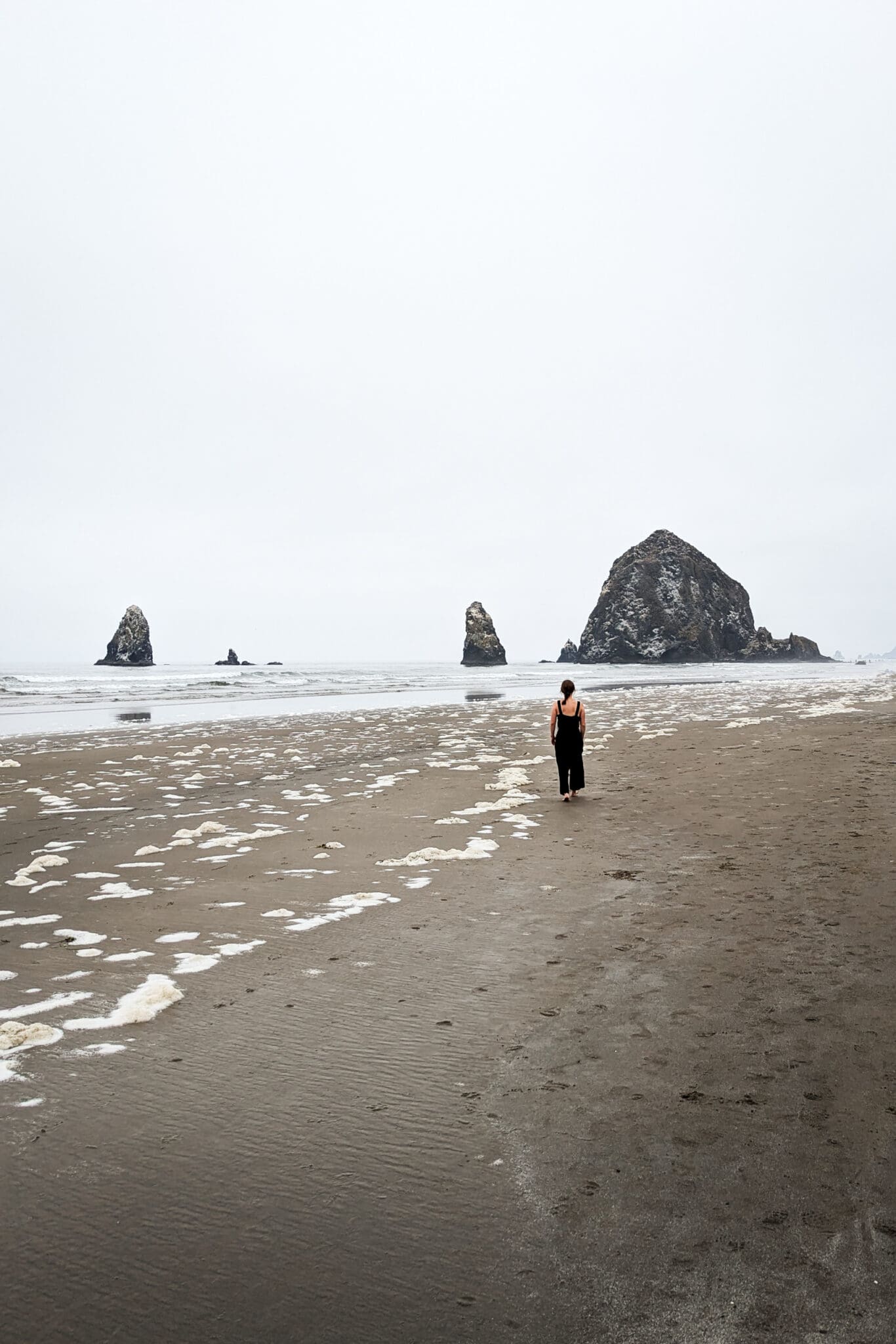 A road trip from Vancouver to Colorado - Woman walking on Cannon Beach, Oregon