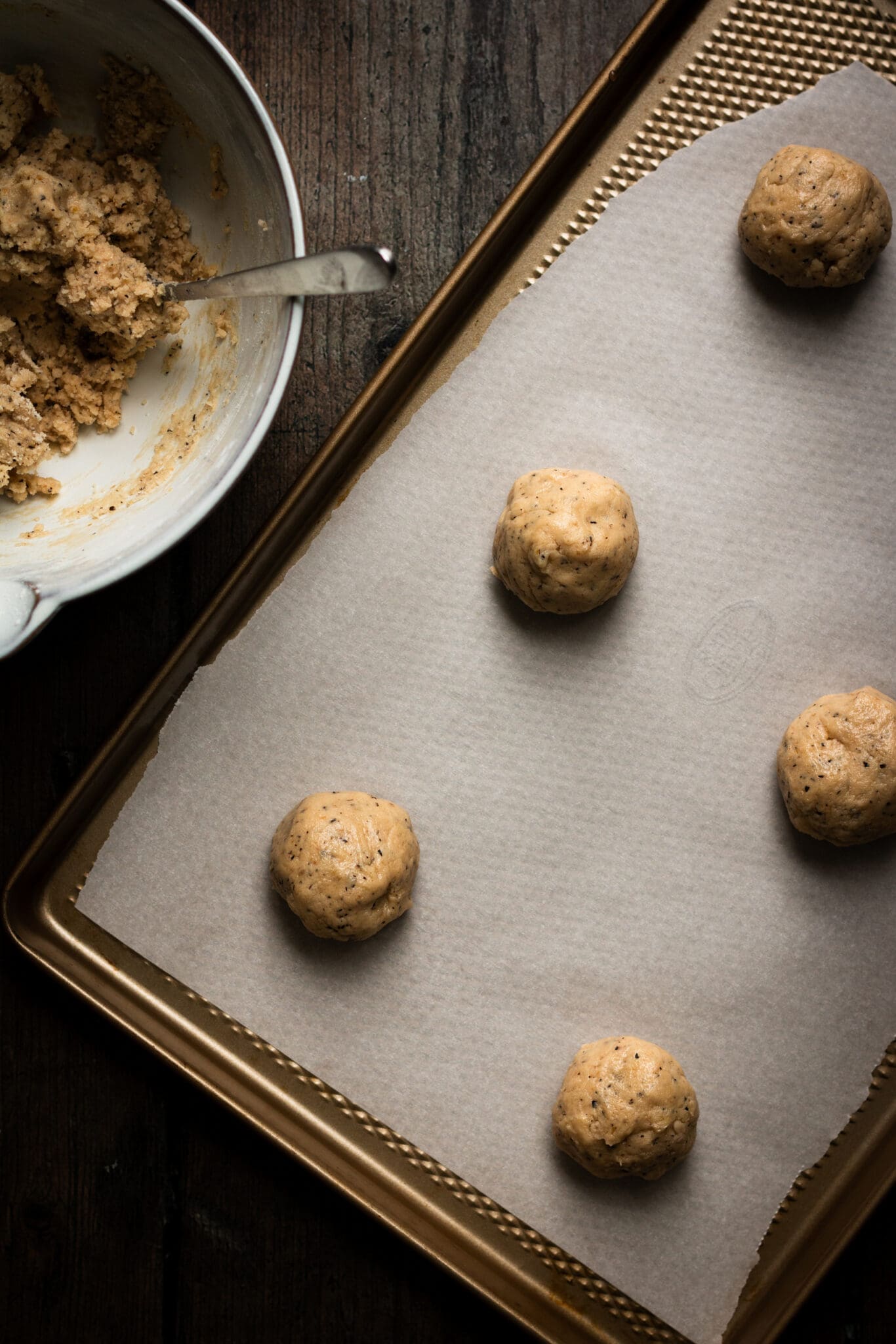 cookie balls on a baking sheet seen from the top