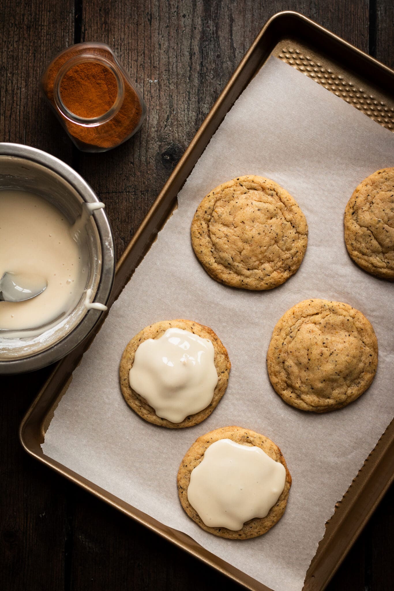 chewy chai cookies on a baking sheet with a glaze