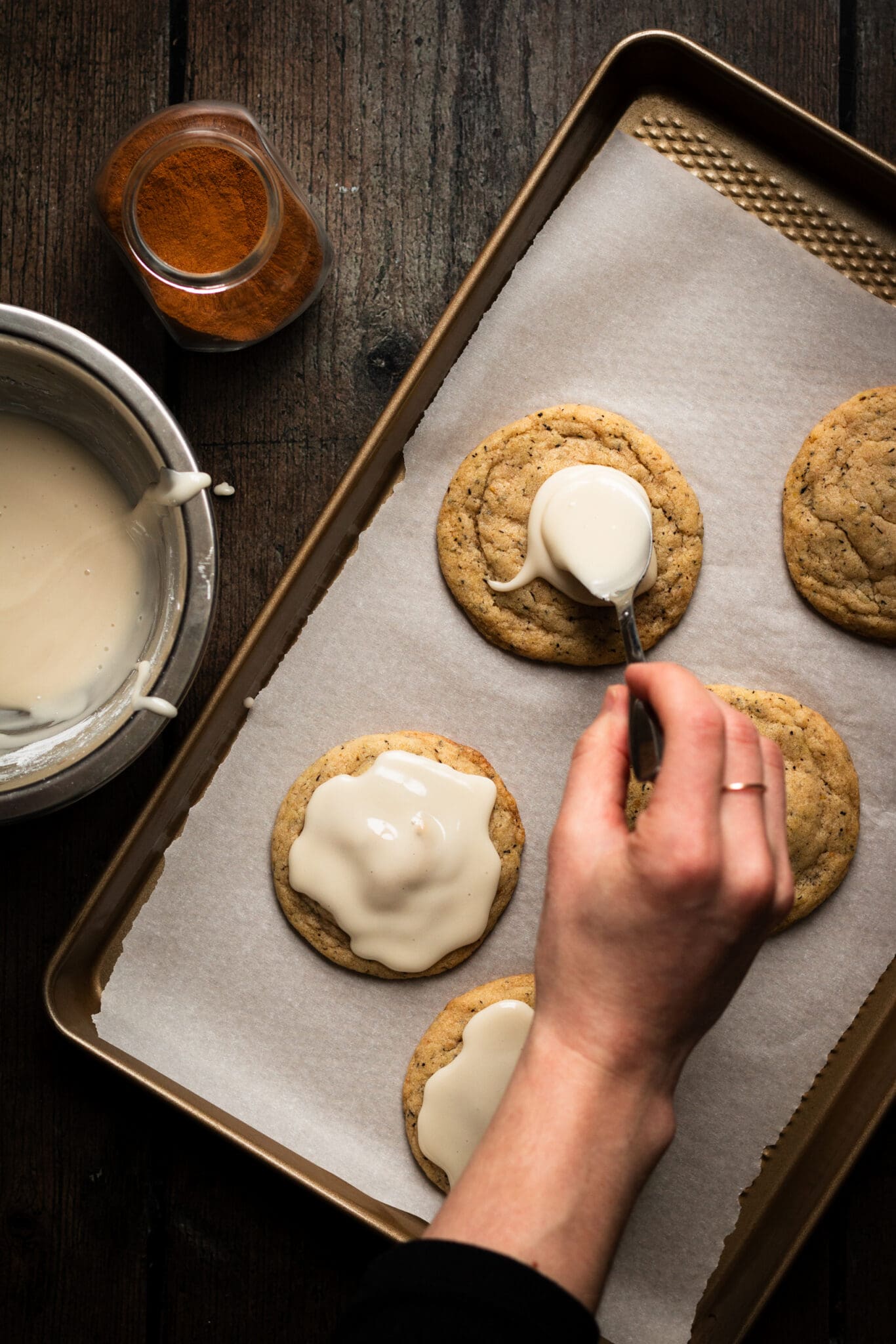 chewy chai cookies being decorated with glaze