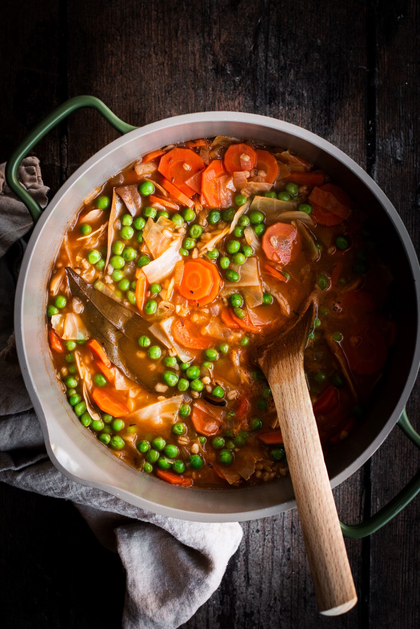 barley and vegetable soup in a large saucepan seen from the top