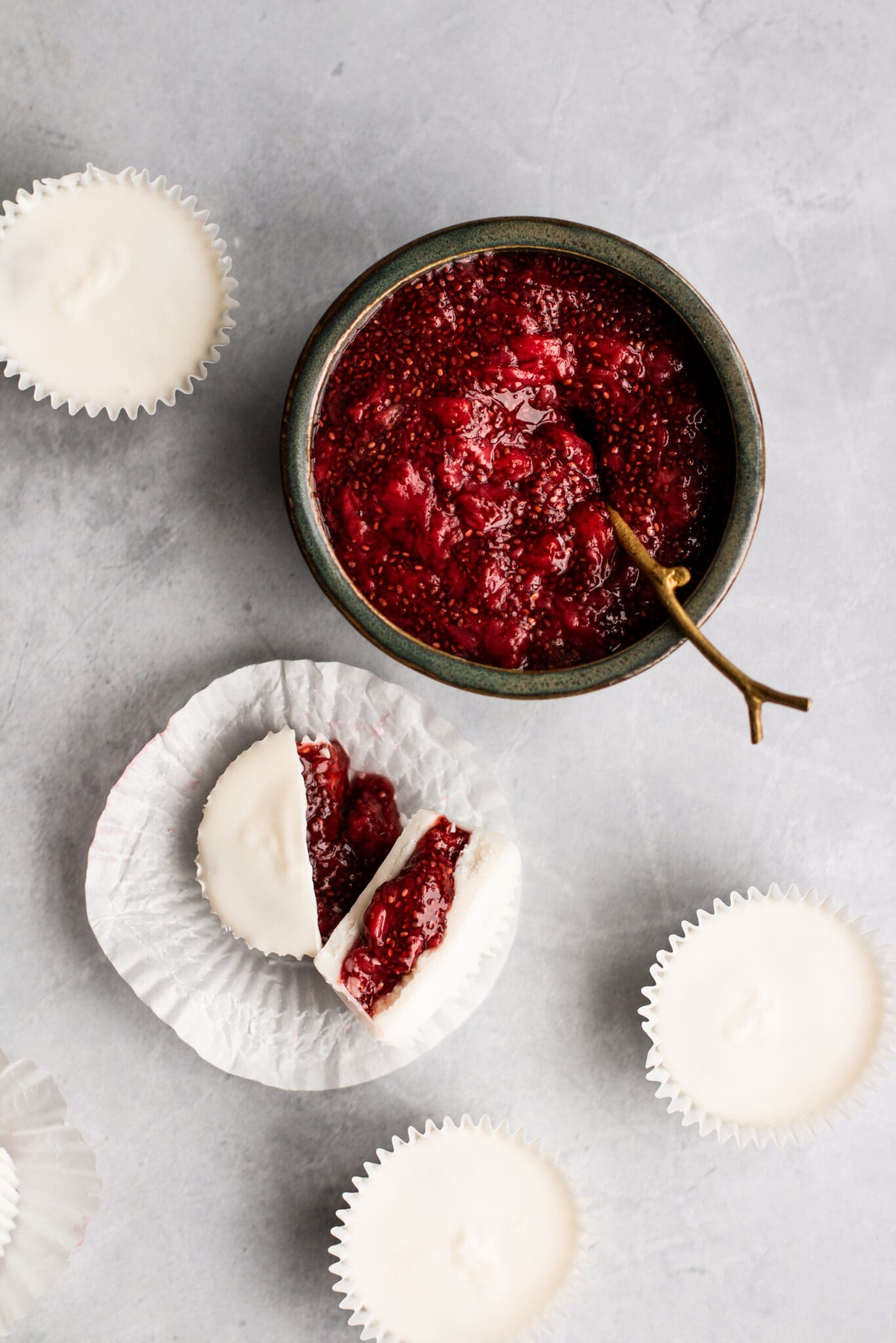 Strawberry chia jam in a bowl with white chocolate cups on the side