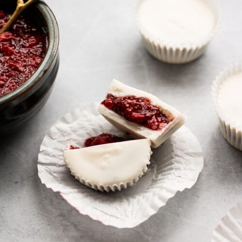 white chocolate cups with strawberry chia jam cut in half