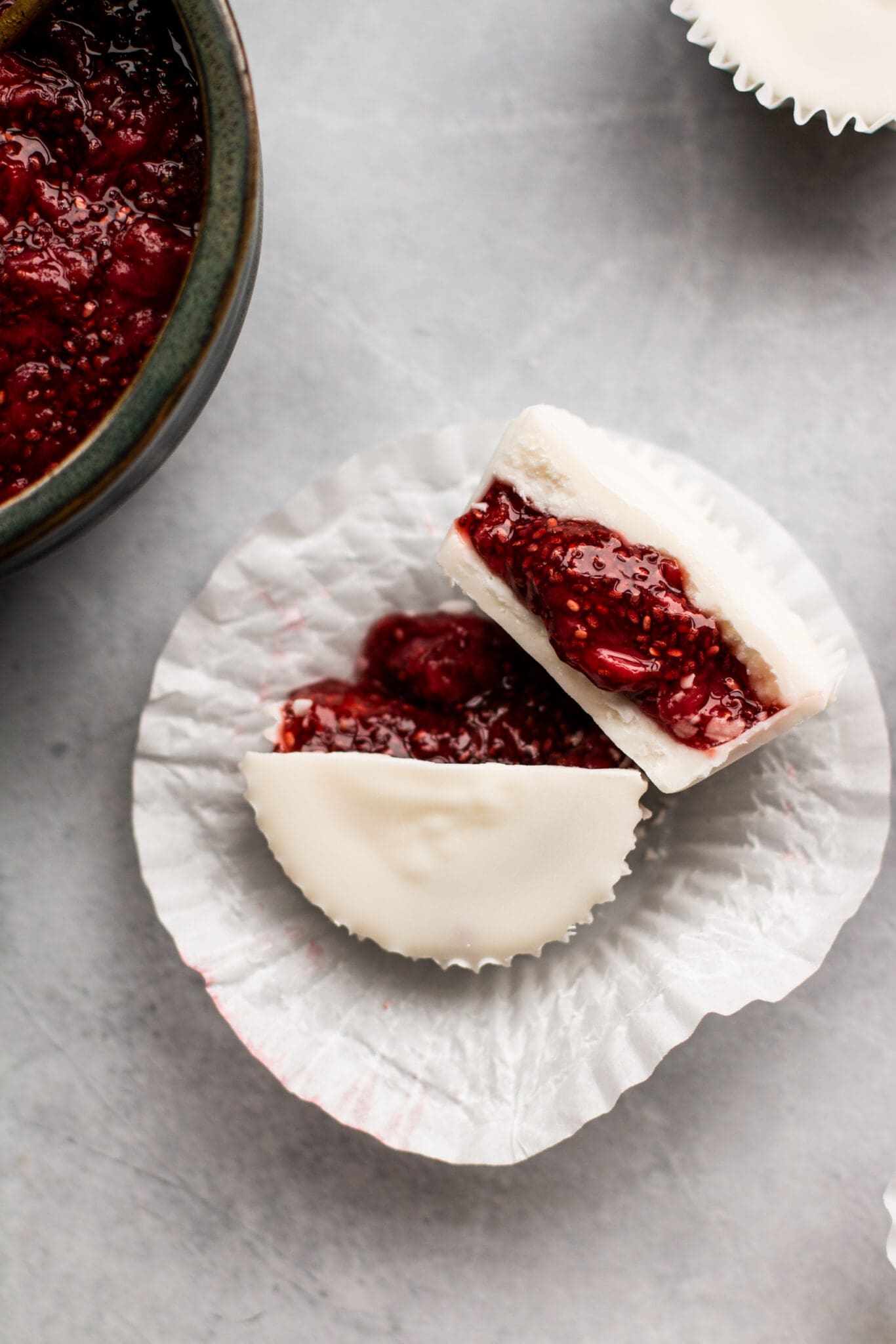 white chocolate cup cut in half with chia jam in the middle