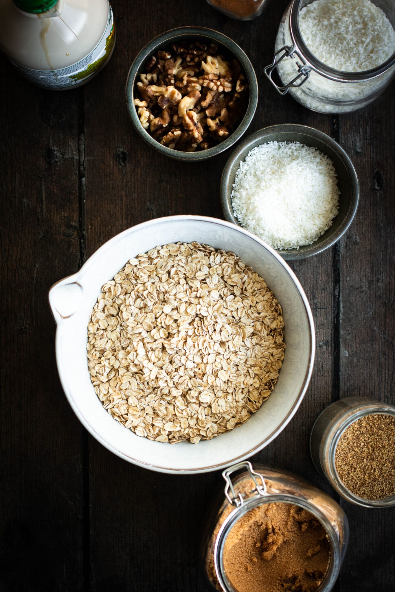 oats, walnuts, brown sugar, coconut and flax in bowls seen from the top