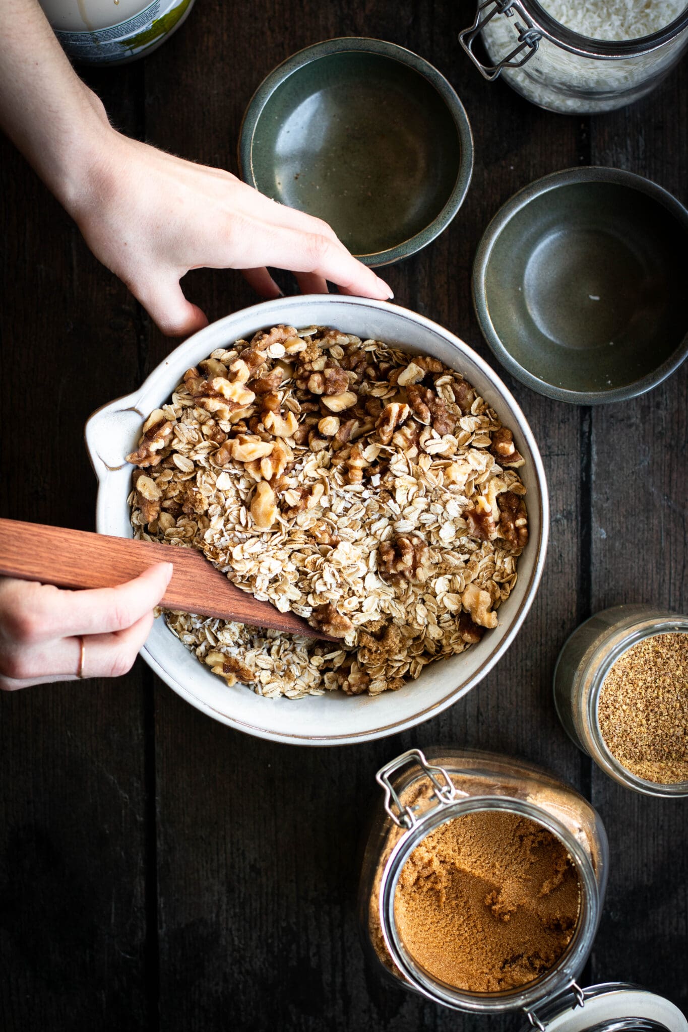 granola mixture being mixed in a bowl