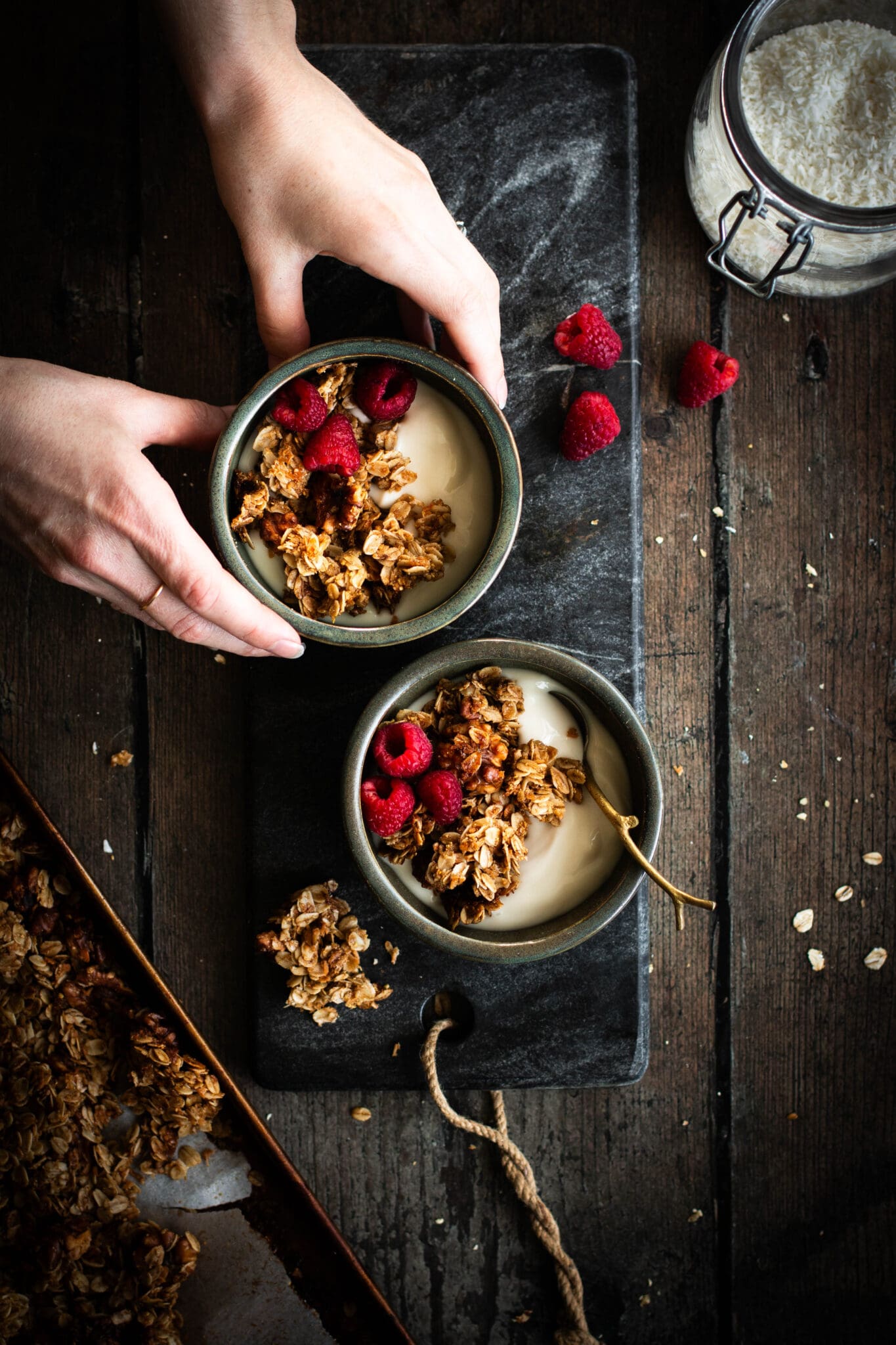 maple walnut granola in bowls with yogurt and raspberries