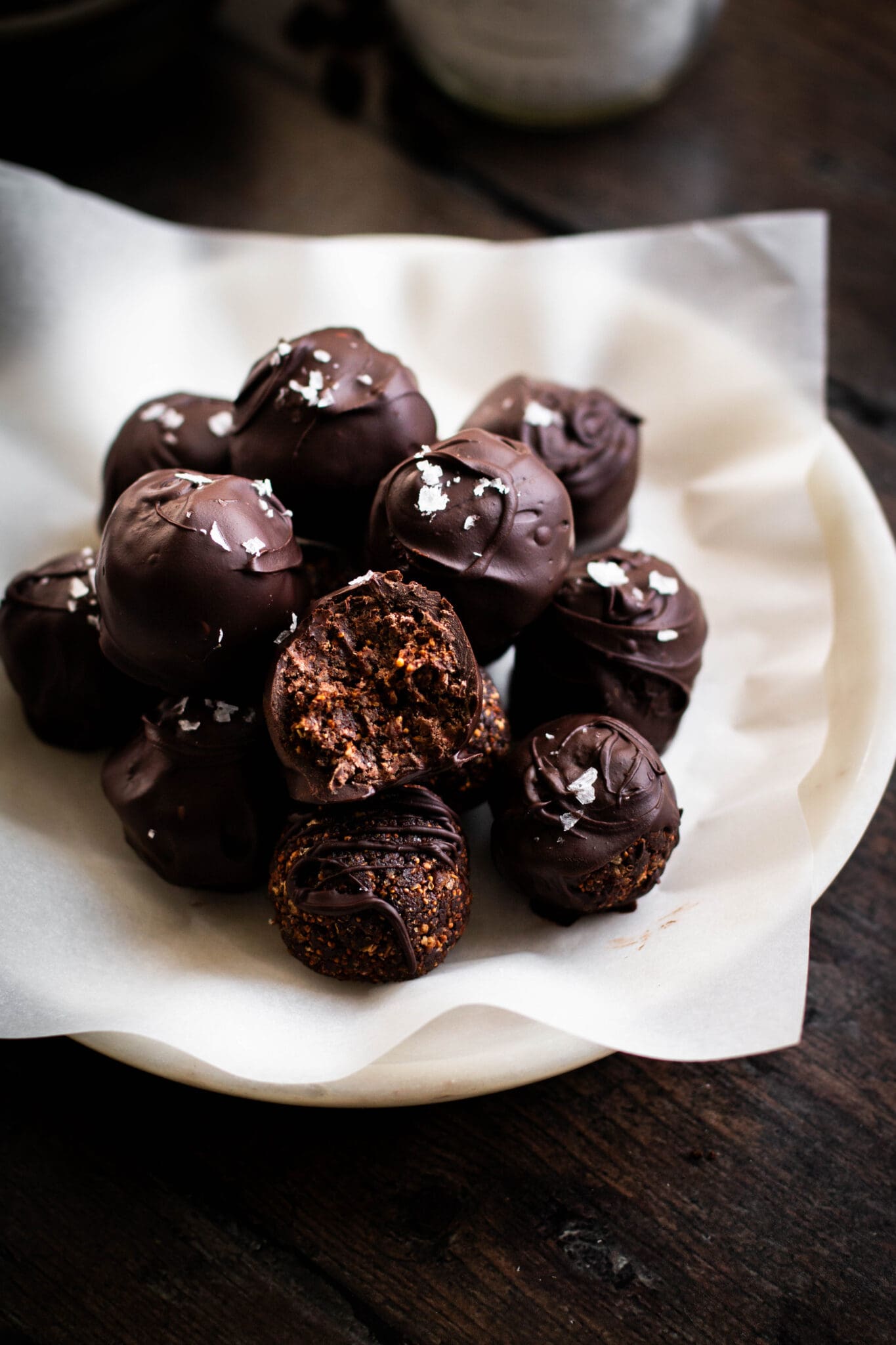 Salted dark chocolate fig truffles closeup with a bite taken.