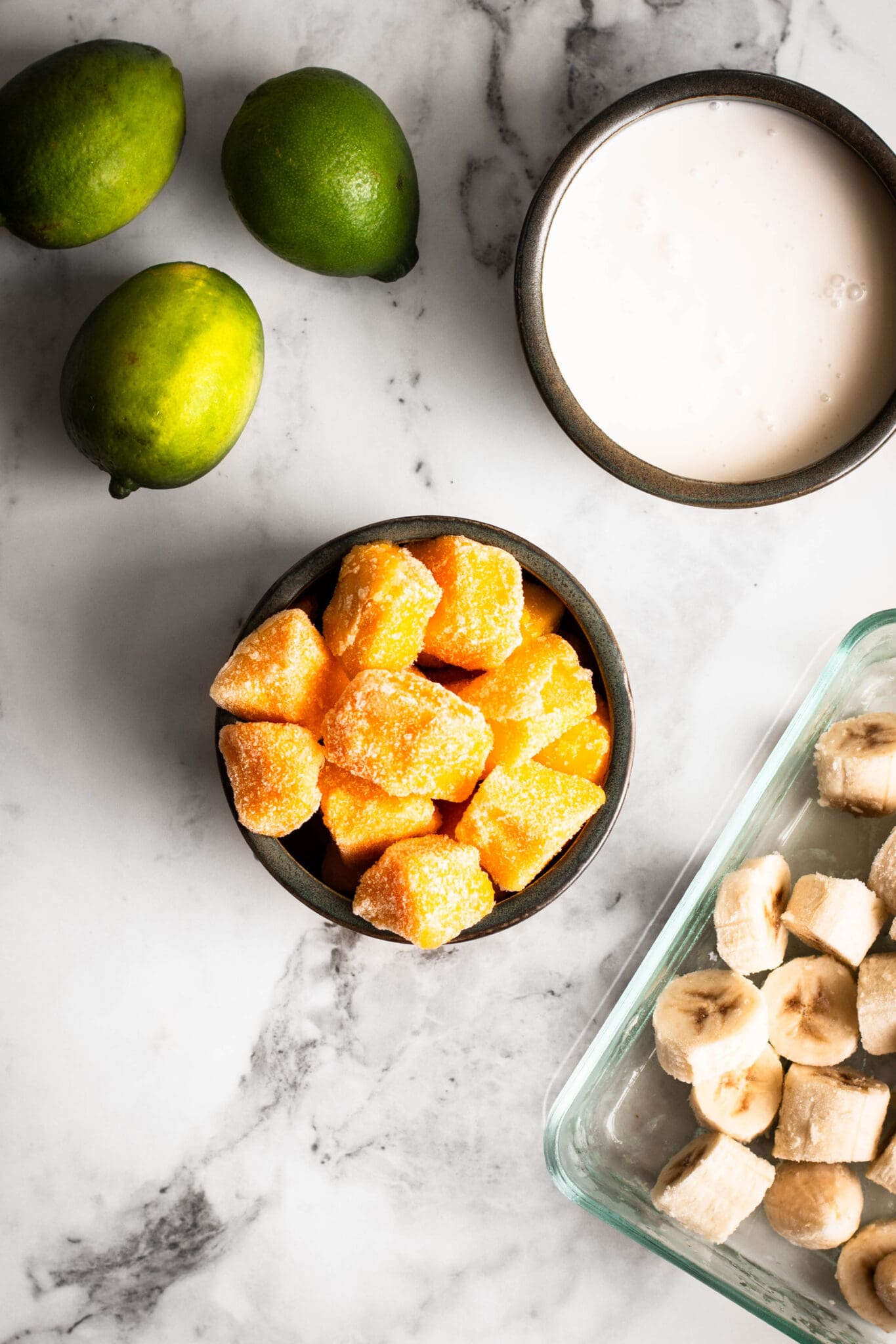 frozen mangoes, bananas, coconut milk and limes