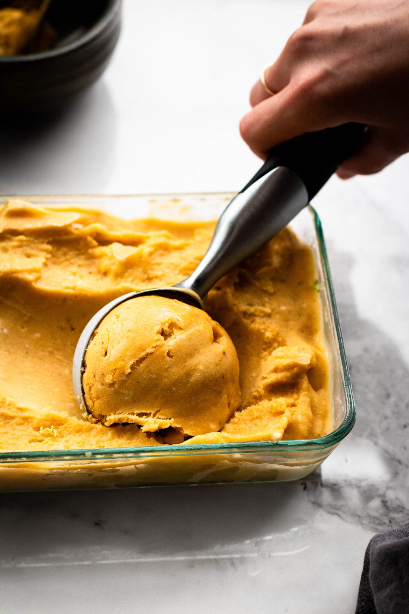 4-ingredient mango banana ice cream scooped from a container