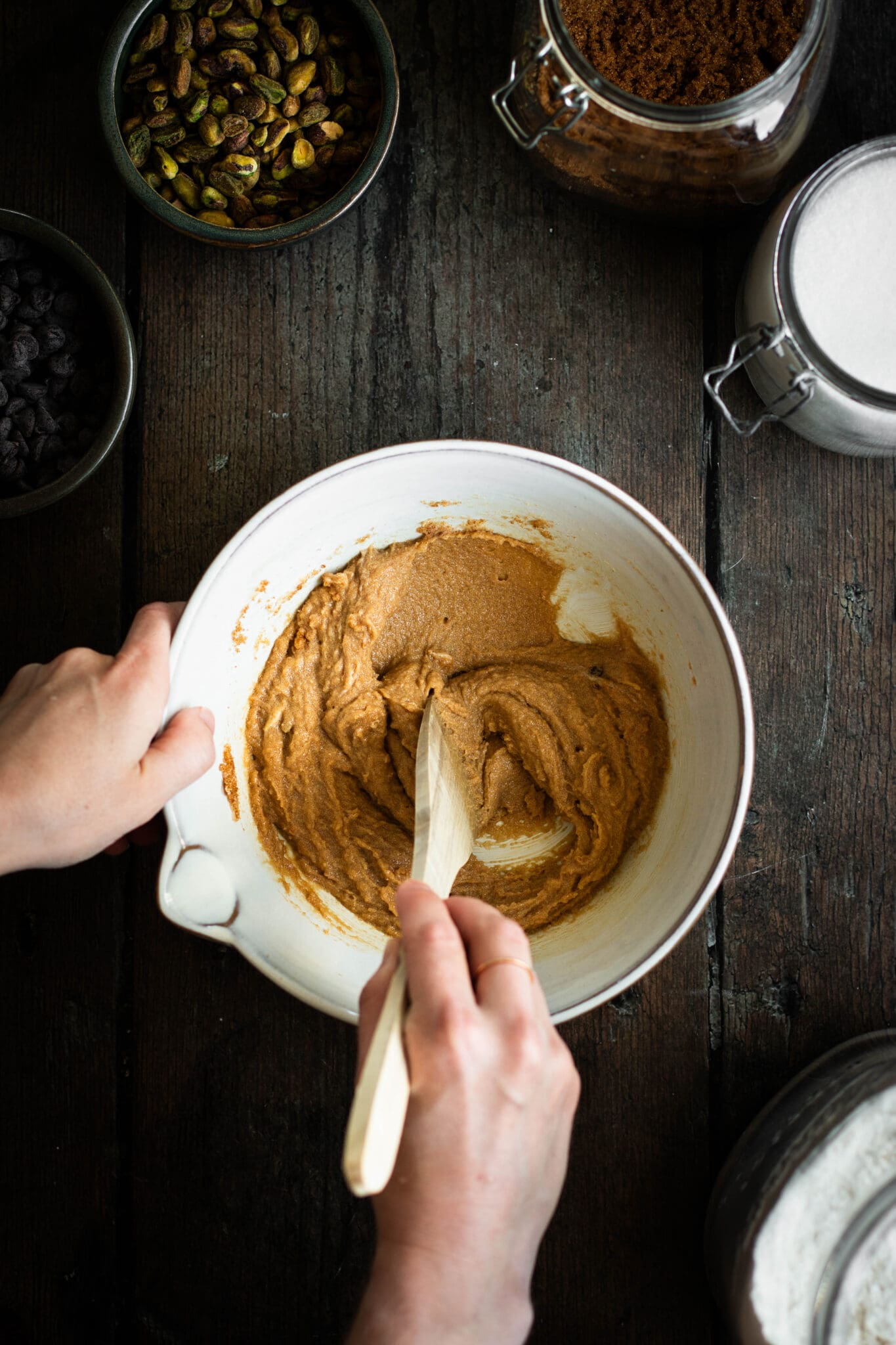 Cookie batter being mixed in a bowl, seen from the top.