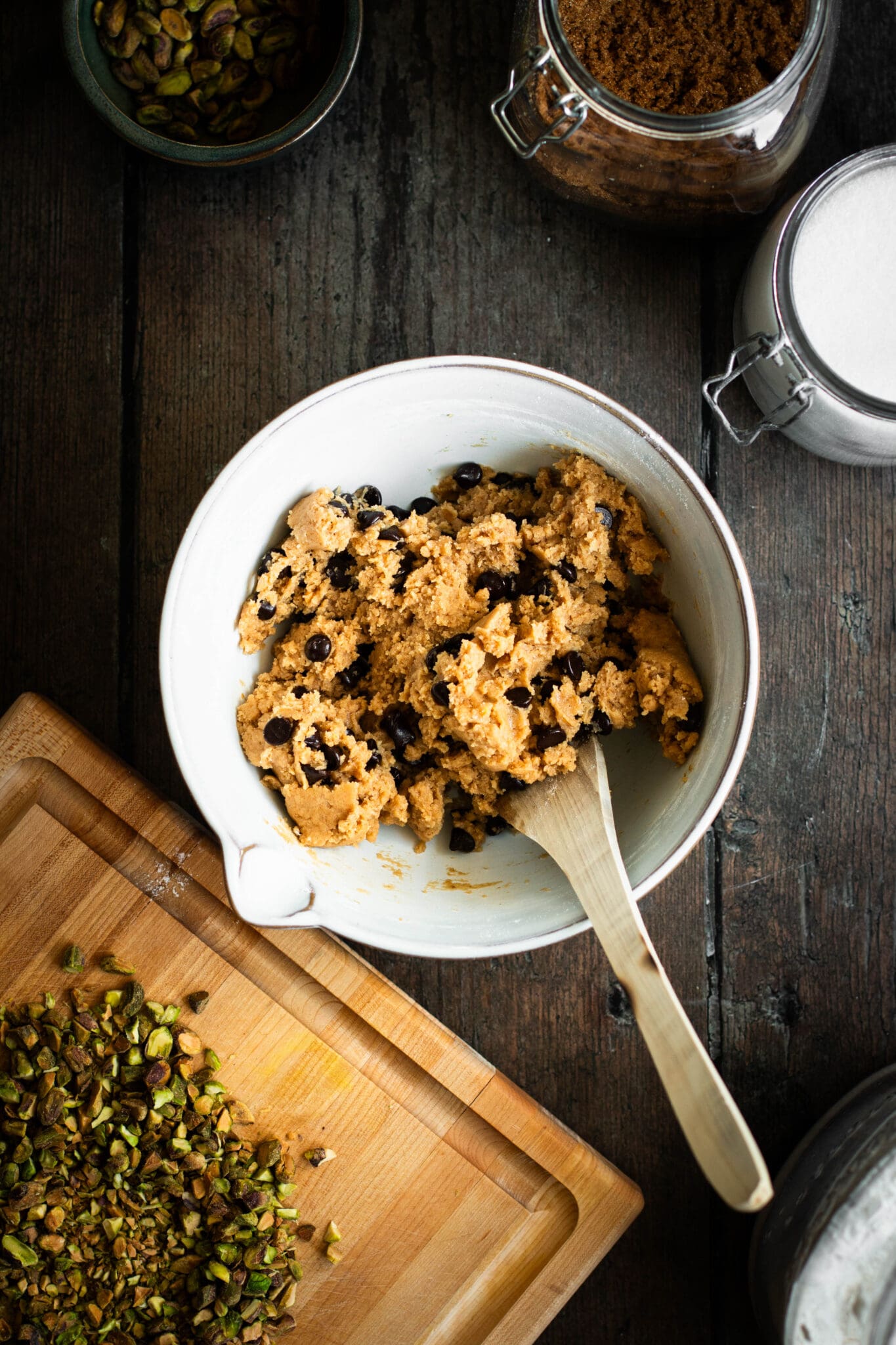 Chocolate chip cookie batter in a bowl seen from the top.