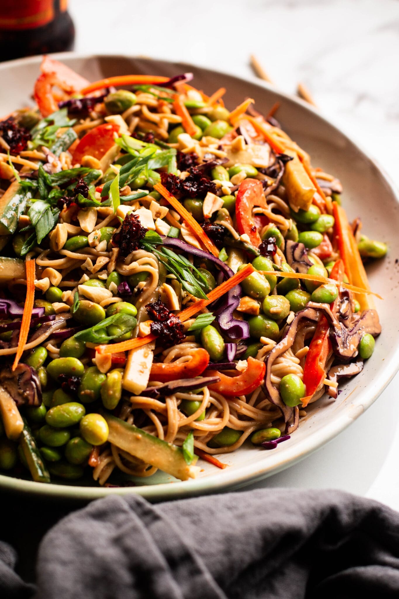 Peanut noodle salad in a large bowl seen from the side.